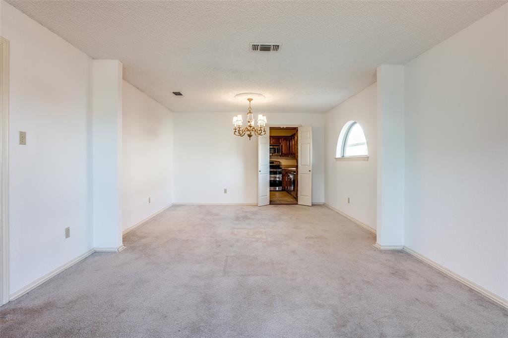 3202 Ridge Oak Drive Garland, TX 75044 - Photo 5 of 25 an empty room with a empty space and windows