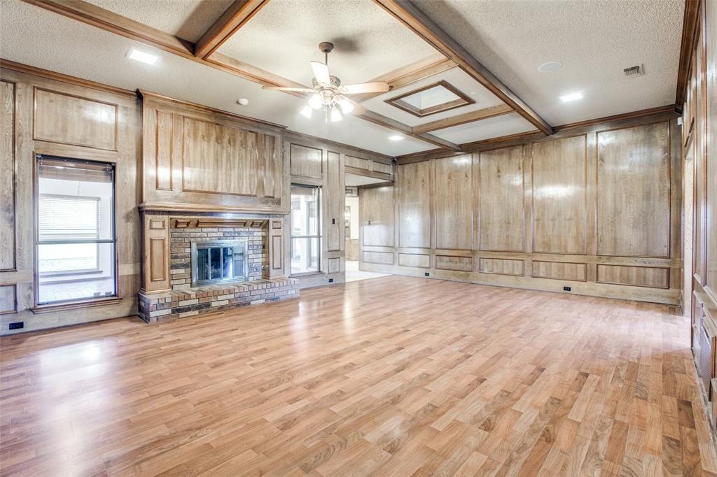 3202 Ridge Oak Drive Garland, TX 75044 - Photo 8 of 25 an empty room with wooden floor fireplace and windows