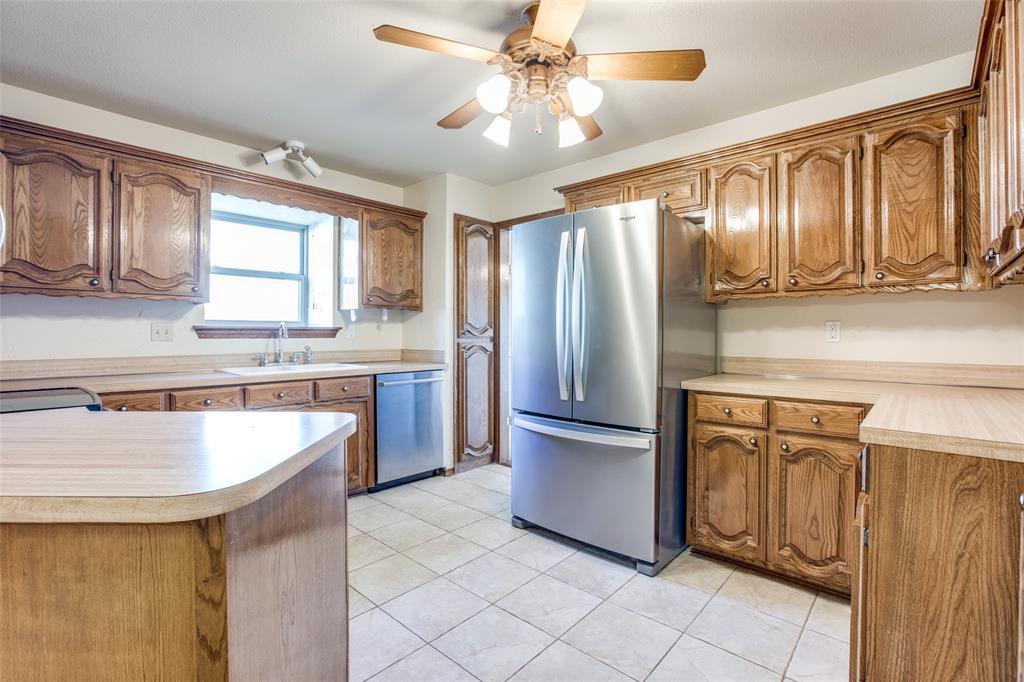 3202 Ridge Oak Drive Garland, TX 75044 - Photo 9 of 25 a kitchen with stainless steel appliances granite countertop a refrigerator a sink and dishwasher