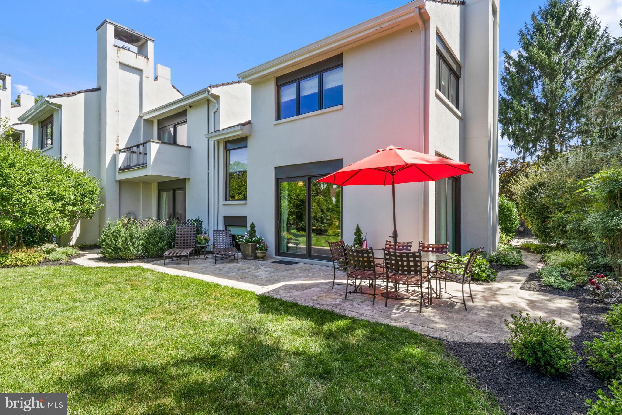a view of a patio with a table and chairs under an umbrella