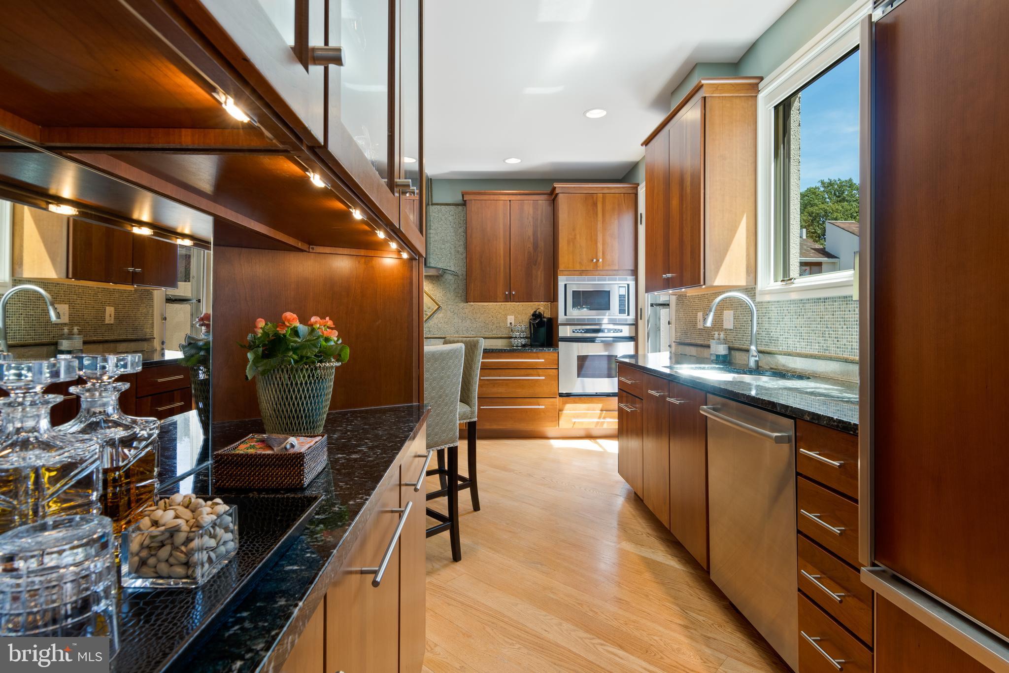 4 Brettagne, Unit 4 Devon, PA 19333 - Photo 11 of 26 a kitchen with stainless steel appliances granite countertop sink stove and cabinets