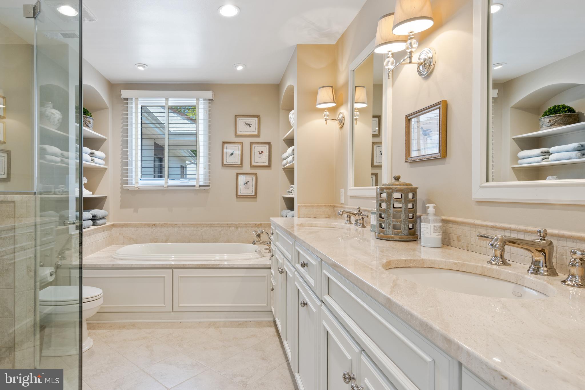4 Brettagne, Unit 4 Devon, PA 19333 - Photo 15 of 26 a bathroom with a granite countertop tub sink and mirror