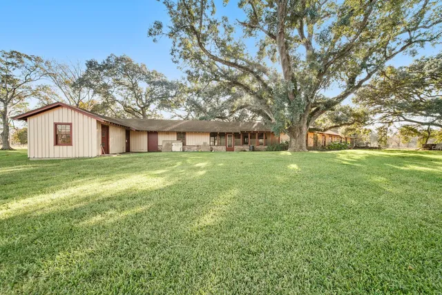 a view of a livingroom with wooden floor and furniture