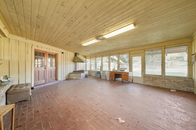 a spacious bedroom with a bed and a large window