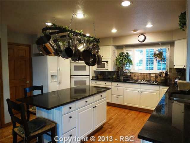 9065 Rutledge Drive Colorado Springs, CO 80920 - Photo 6 of 25 Perfect kitchen for the gourmet chef with upgraded 5 burner gas stove and double oven.