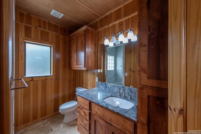 a view of a hallway with wooden shelves