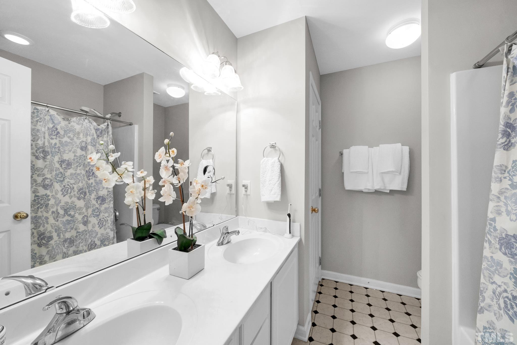 9553 Hanging Rock Road Raleigh, NC 27613 - Photo 15 of 36 a bathroom with a sink and a mirror