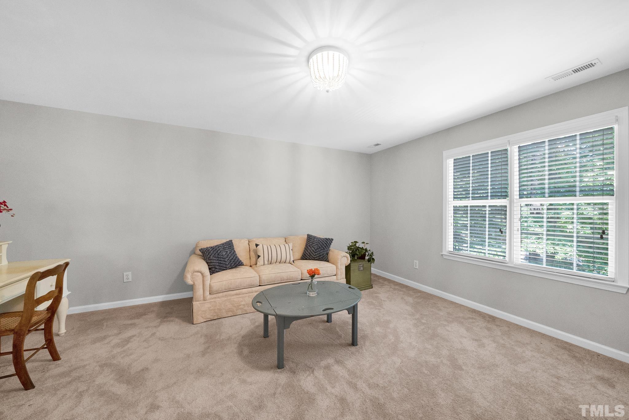 9553 Hanging Rock Road Raleigh, NC 27613 - Photo 22 of 36 a living room with furniture and a window