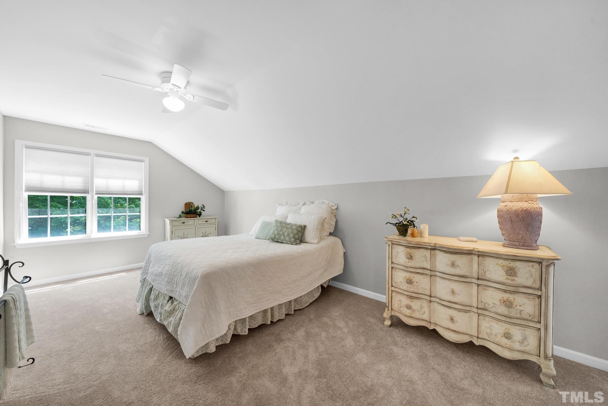 9553 Hanging Rock Road Raleigh, NC 27613 - Photo 23 of 36 a bedroom with a bed chandelier and window