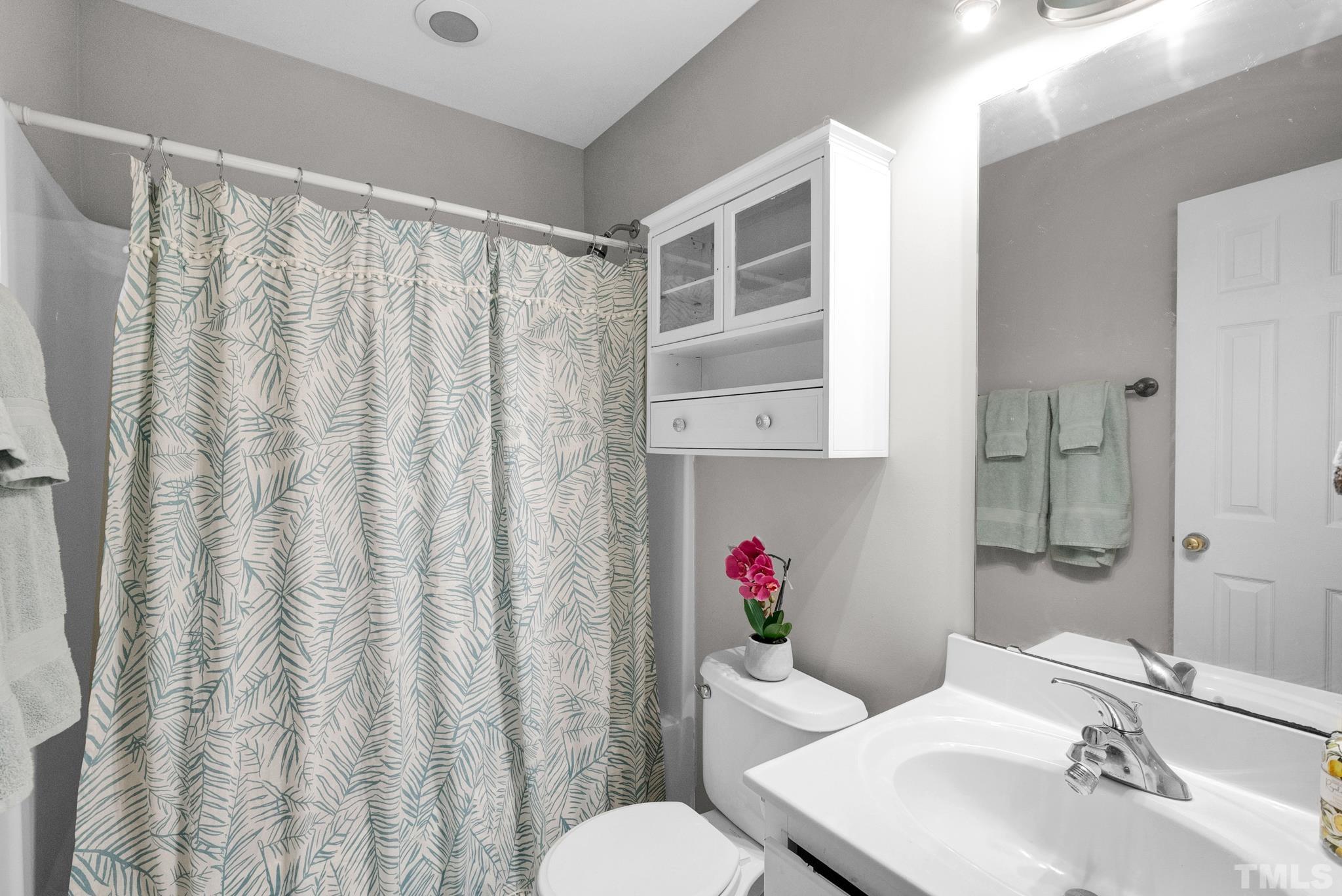 9553 Hanging Rock Road Raleigh, NC 27613 - Photo 25 of 36 a bathroom with a sink and a mirror
