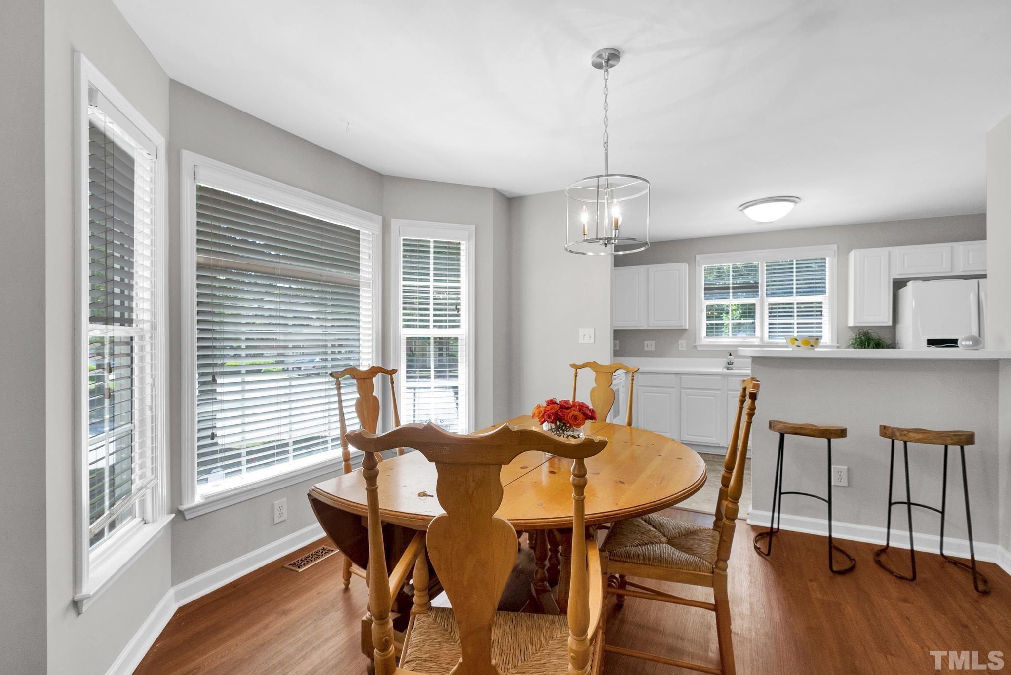 9553 Hanging Rock Road Raleigh, NC 27613 - Photo 4 of 36 a view of a dining room with furniture window and wooden floor