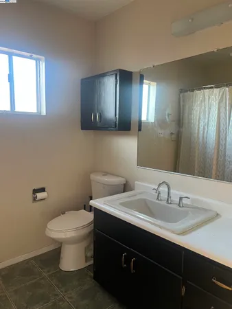 a bathroom with a sink toilet and mirror