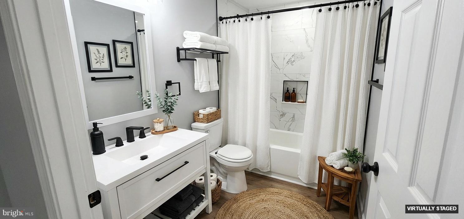 8537 Creek Road Pasadena, MD 21122 - Photo 11 of 24 a bathroom with a sink toilet and shower