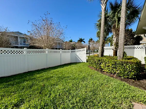 a view of a garden with wooden fence