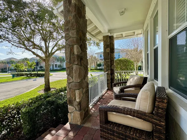 a view of a patio with couches table and chairs and potted plants