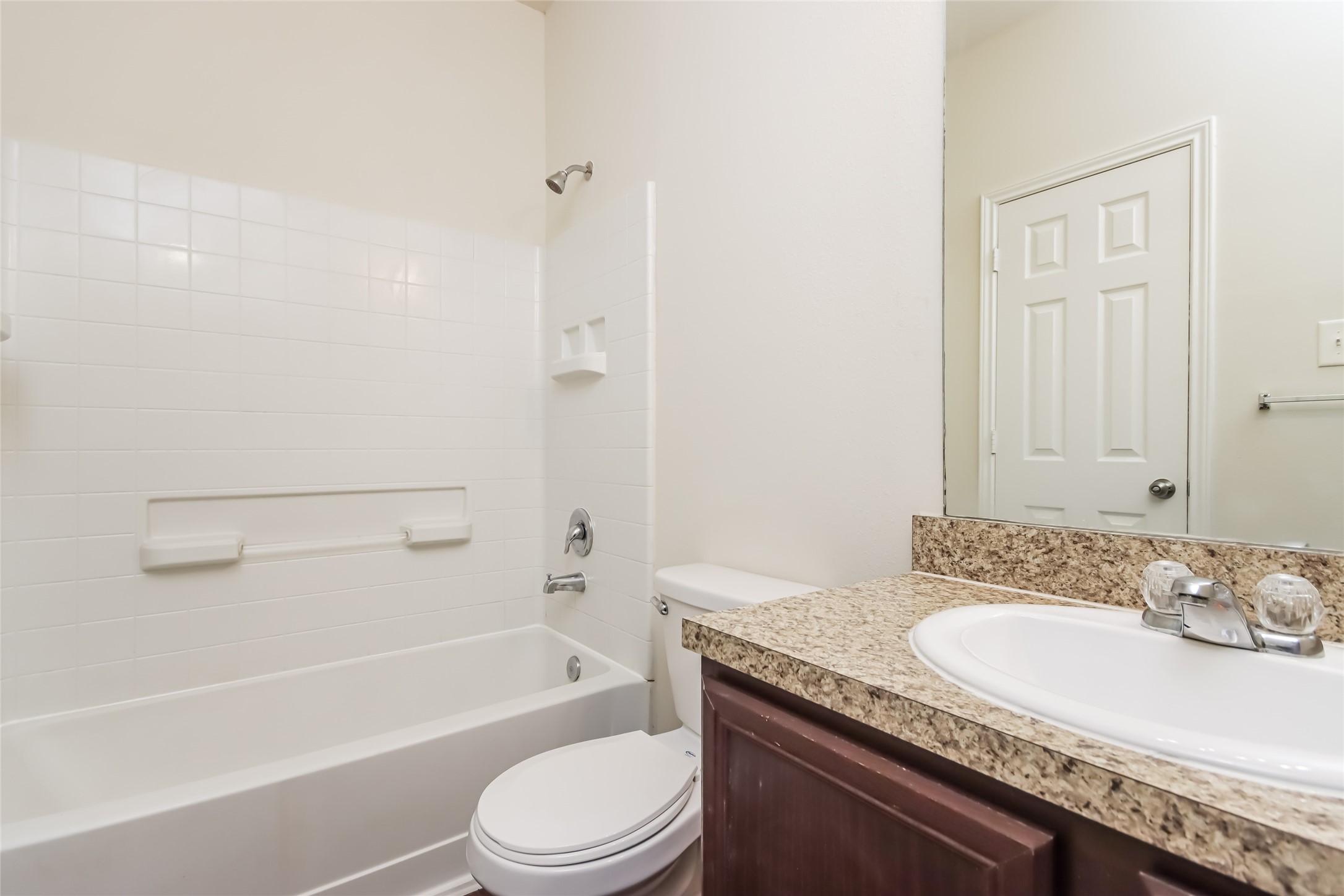 12215 Roy Mix Bohn Lane Houston, TX 77044 - Photo 11 of 17 a bathroom with a granite countertop sink a toilet and bathtub