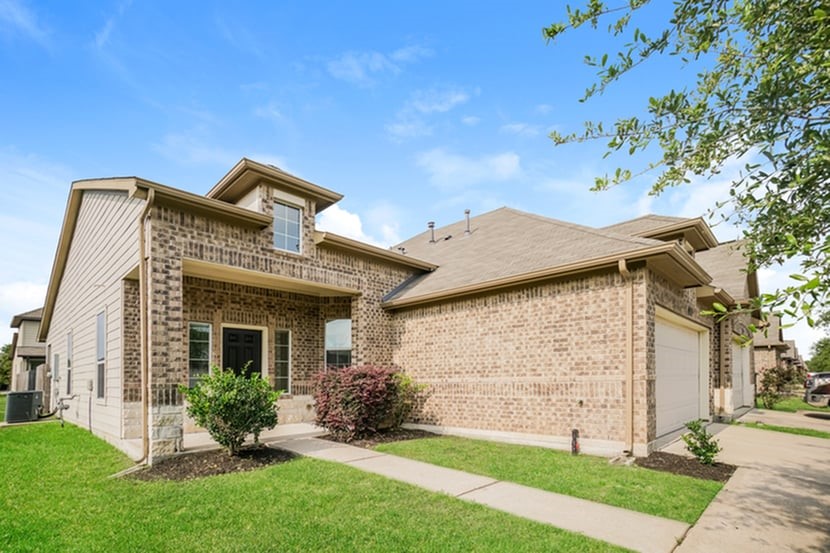 12215 Roy Mix Bohn Lane Houston, TX 77044 - Photo 2 of 17 a front view of a house with garden
