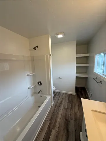 a bathroom with a bathtub and a shower