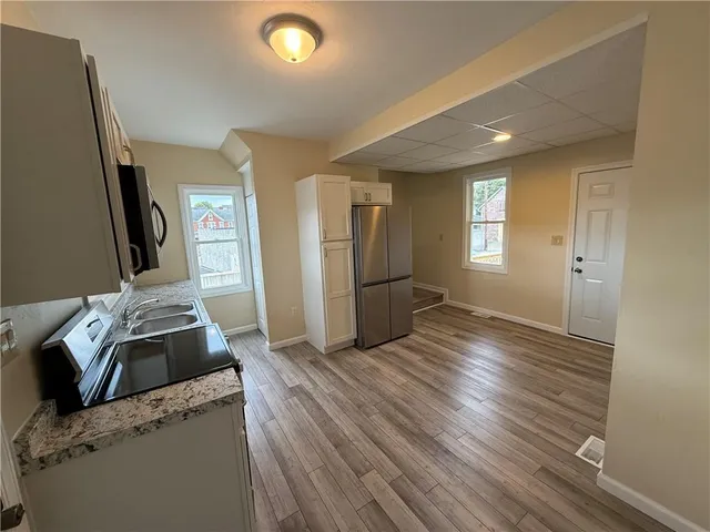 a kitchen with sink and refrigerator