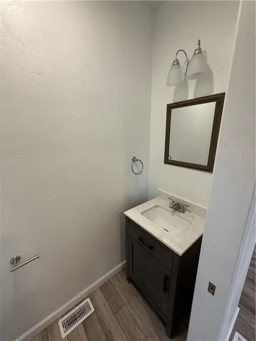 a bathroom with a sink toilet and mirror