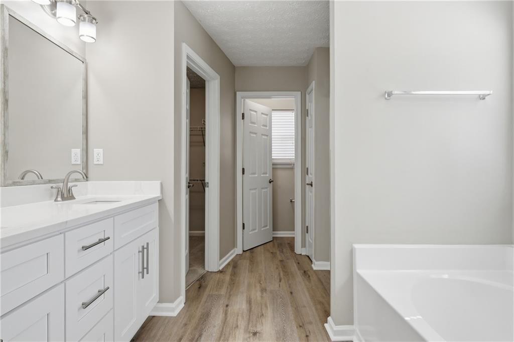 3570 Bogan Mill Road Northeast Buford, GA 30519 - Photo 20 of 31 a bathroom with a tub sink and mirror