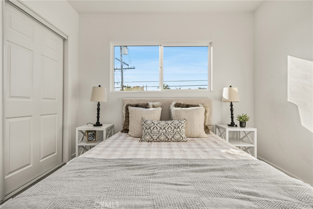 6725 Perry Road Bell Gardens, CA 90201 - Photo 26 of 40 a bedroom with a bed and a night stand