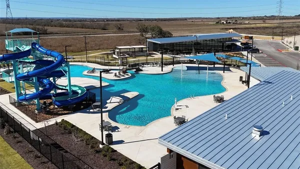 a room with lots of chairs and wooden floor