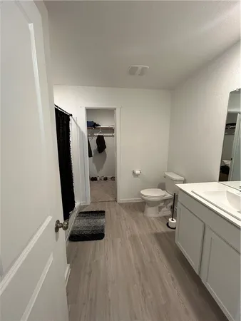 a bathroom with a sink toilet and mirror