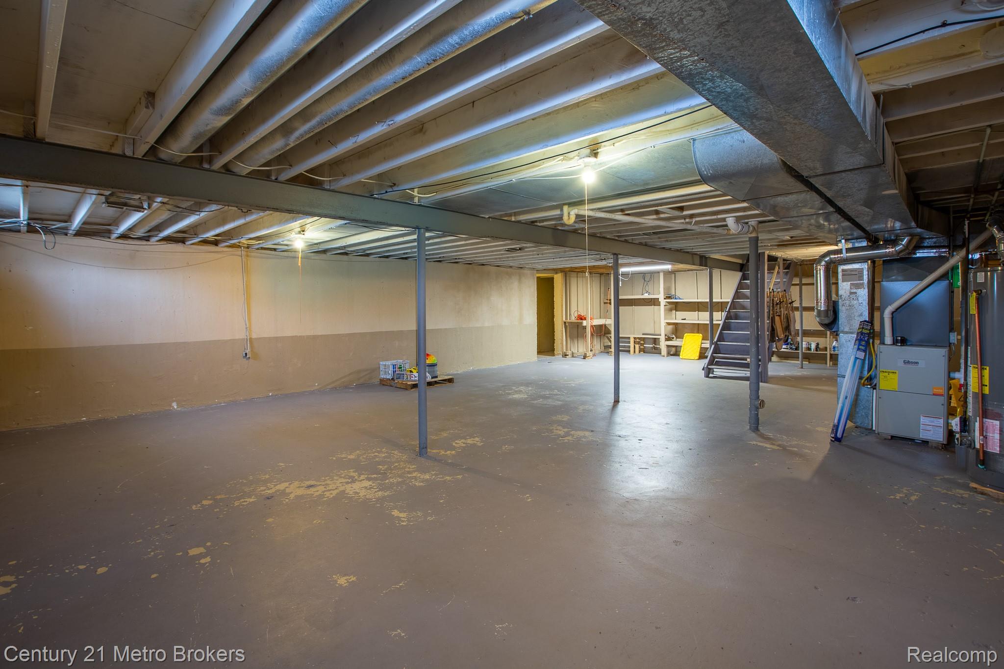 6101 Belsay Road Grand Blanc, MI 48439 - Photo 23 of 28 Unfinished below grade area featuring heating unit and gas water heater