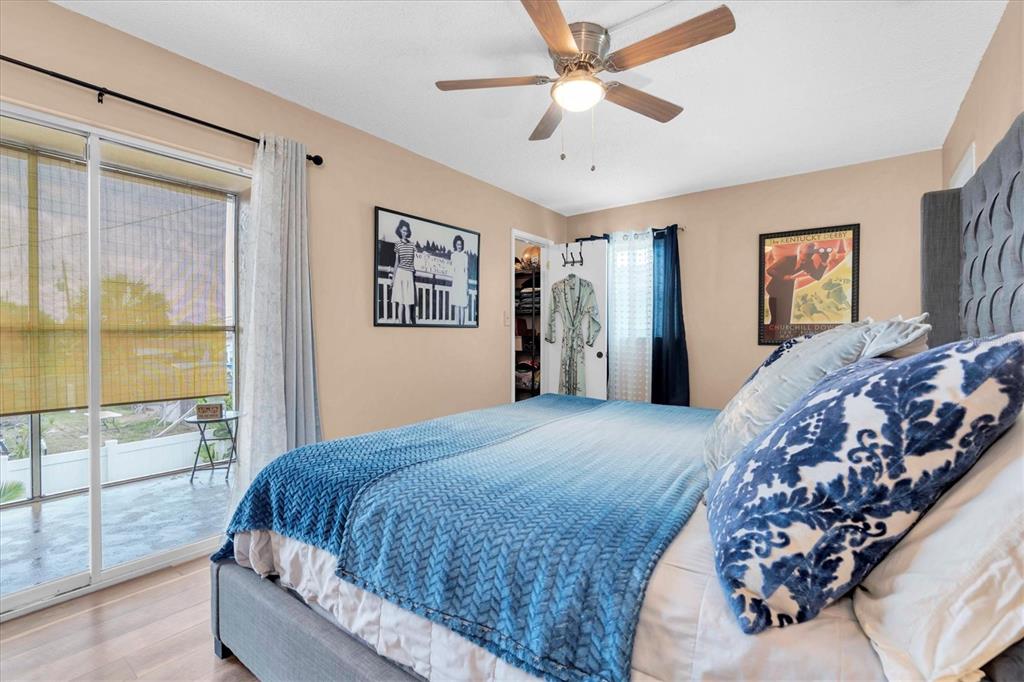 8800 Blind Pass Road, Unit 10 St. Pete Beach, FL 33706 - Photo 11 of 24 a bedroom with a large bed and a chandelier