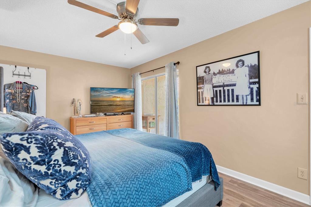 8800 Blind Pass Road, Unit 10 St. Pete Beach, FL 33706 - Photo 13 of 24 a bedroom with a large bed dresser and a window