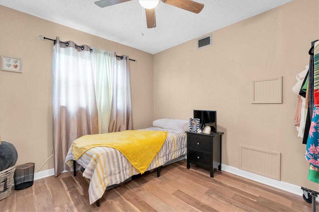 8800 Blind Pass Road, Unit 10 St. Pete Beach, FL 33706 - Photo 17 of 24 a bedroom with a bed and a window