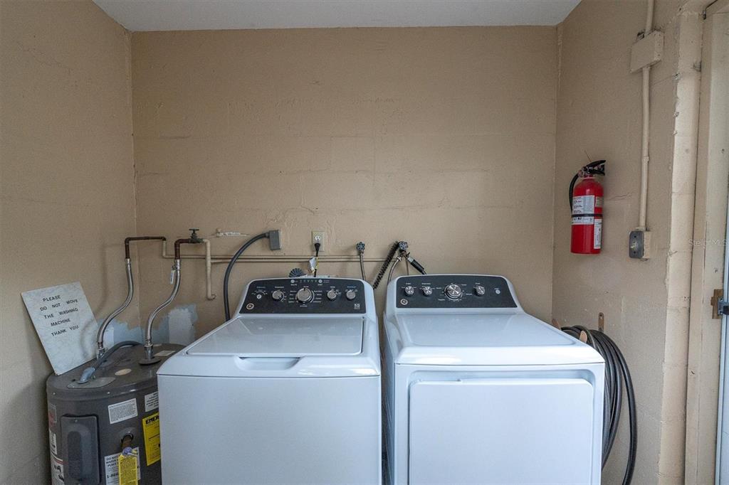 8800 Blind Pass Road, Unit 10 St. Pete Beach, FL 33706 - Photo 19 of 24 a utility room with dryer and washer