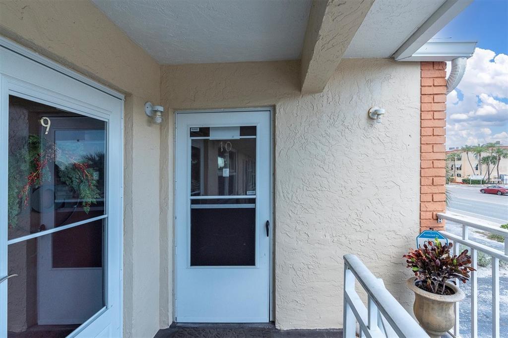 8800 Blind Pass Road, Unit 10 St. Pete Beach, FL 33706 - Photo 2 of 24 a view of a hallway and a livingroom with furniture