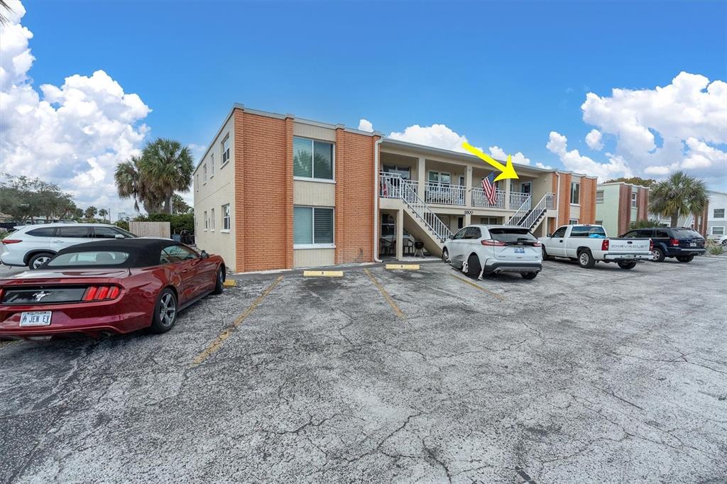 8800 Blind Pass Road, Unit 10 St. Pete Beach, FL 33706 - Photo 24 of 24 a view of a cars park in front of a building