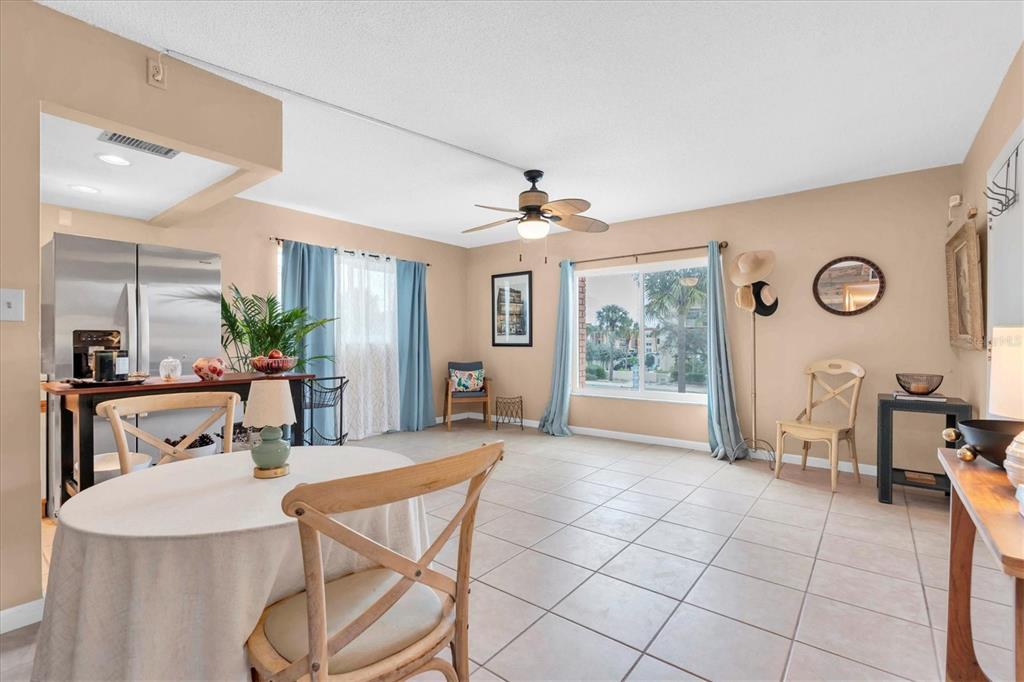 8800 Blind Pass Road, Unit 10 St. Pete Beach, FL 33706 - Photo 6 of 24 a view of a dining room with furniture and a window