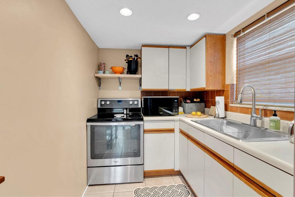 8800 Blind Pass Road, Unit 10 St. Pete Beach, FL 33706 - Photo 10 of 24 a kitchen with a stove and a sink
