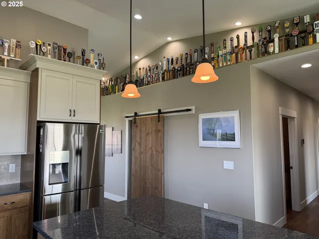 a view of a room with lots of appliances and cabinets