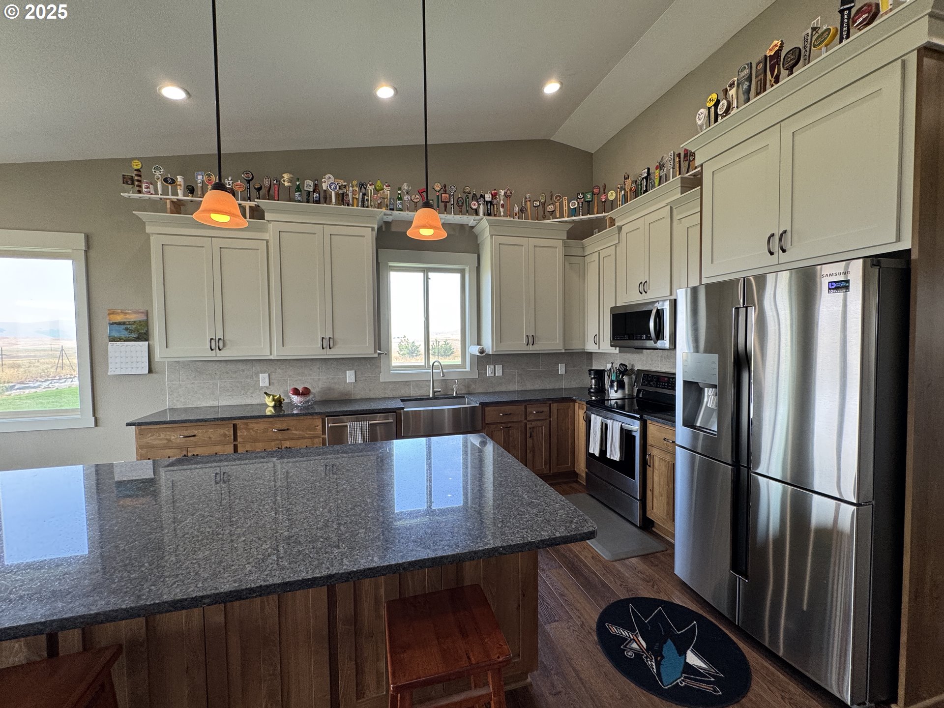 1818 Centerville Highway Centerville, WA 98613 - Photo 18 of 42 a kitchen with stainless steel appliances granite countertop a refrigerator a sink dishwasher a stove a dining table and chairs with wooden floor