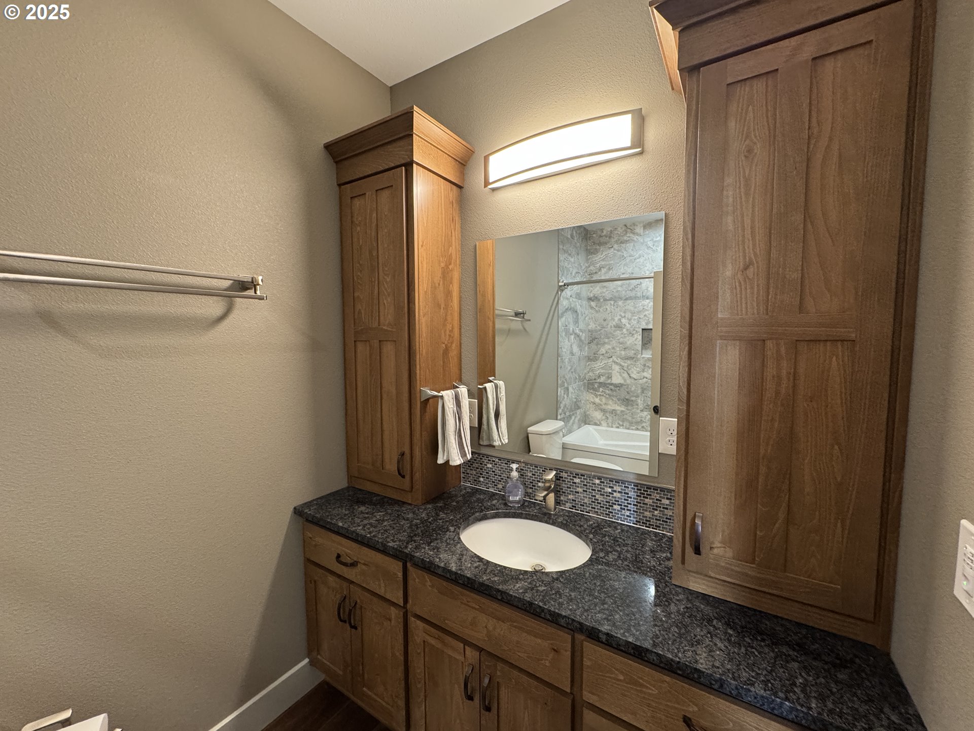 1818 Centerville Highway Centerville, WA 98613 - Photo 21 of 42 a bathroom with a granite countertop sink a mirror and a shower