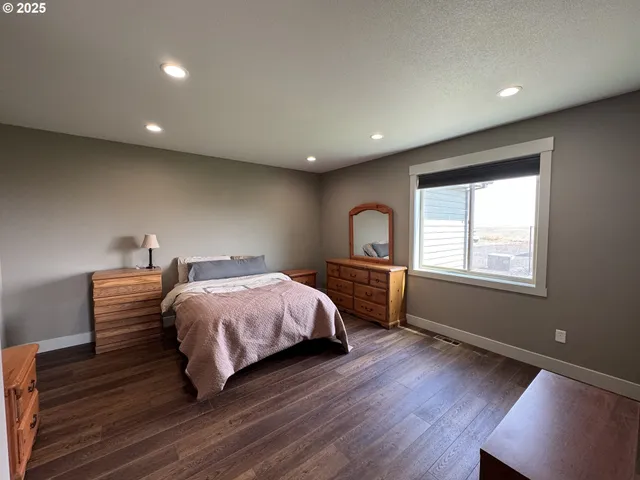 a spacious bedroom with a bed and a window