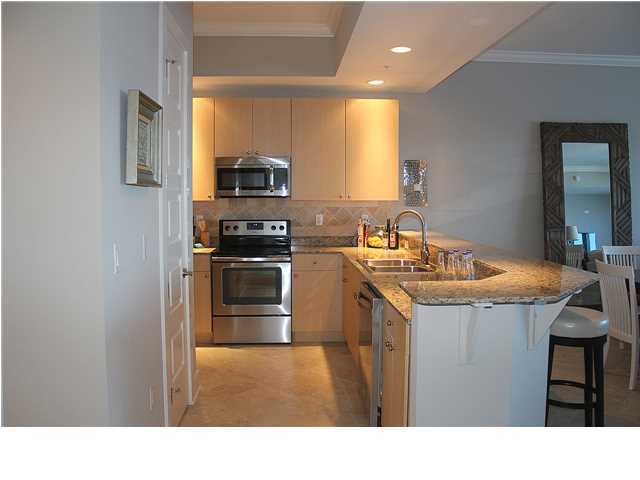 211 Durango Road, Unit 416 Destin, FL 32541 - Photo 11 of 34 a kitchen with granite countertop a sink stove and refrigerator