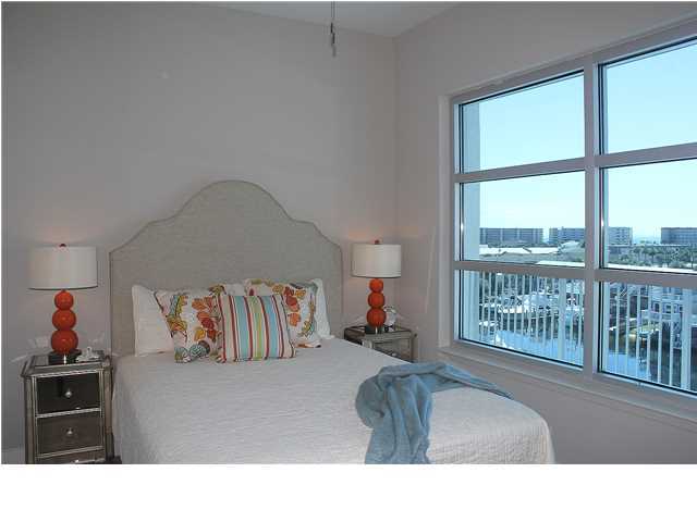211 Durango Road, Unit 416 Destin, FL 32541 - Photo 19 of 34 a bedroom with a bed and glass window