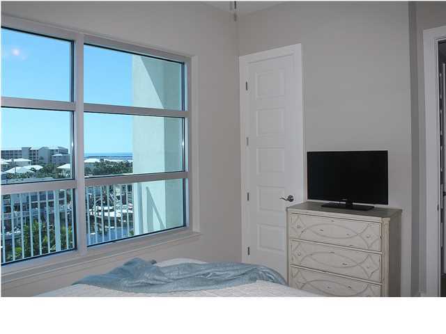 211 Durango Road, Unit 416 Destin, FL 32541 - Photo 20 of 34 a living room with a flat screen tv a rug and a window