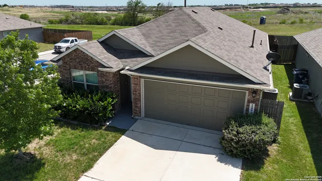 a house with lots of trees in the background
