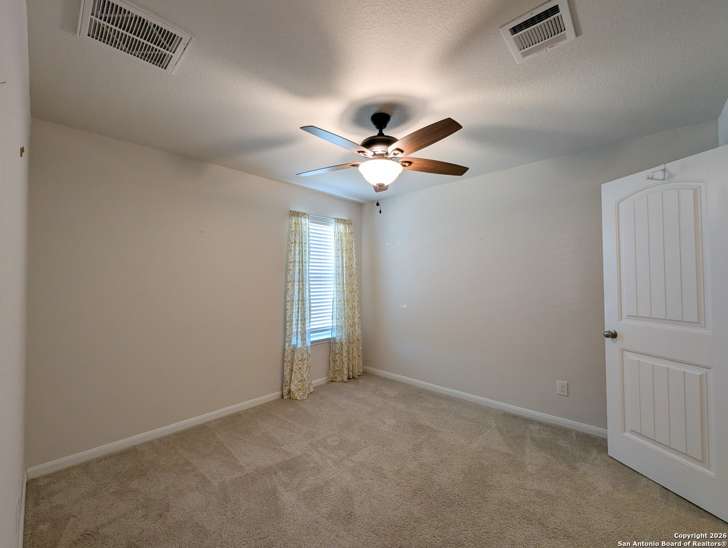 2494 McCrae New Braunfels, TX 78130 - Photo 19 of 22 an empty room with ceiling fan and window