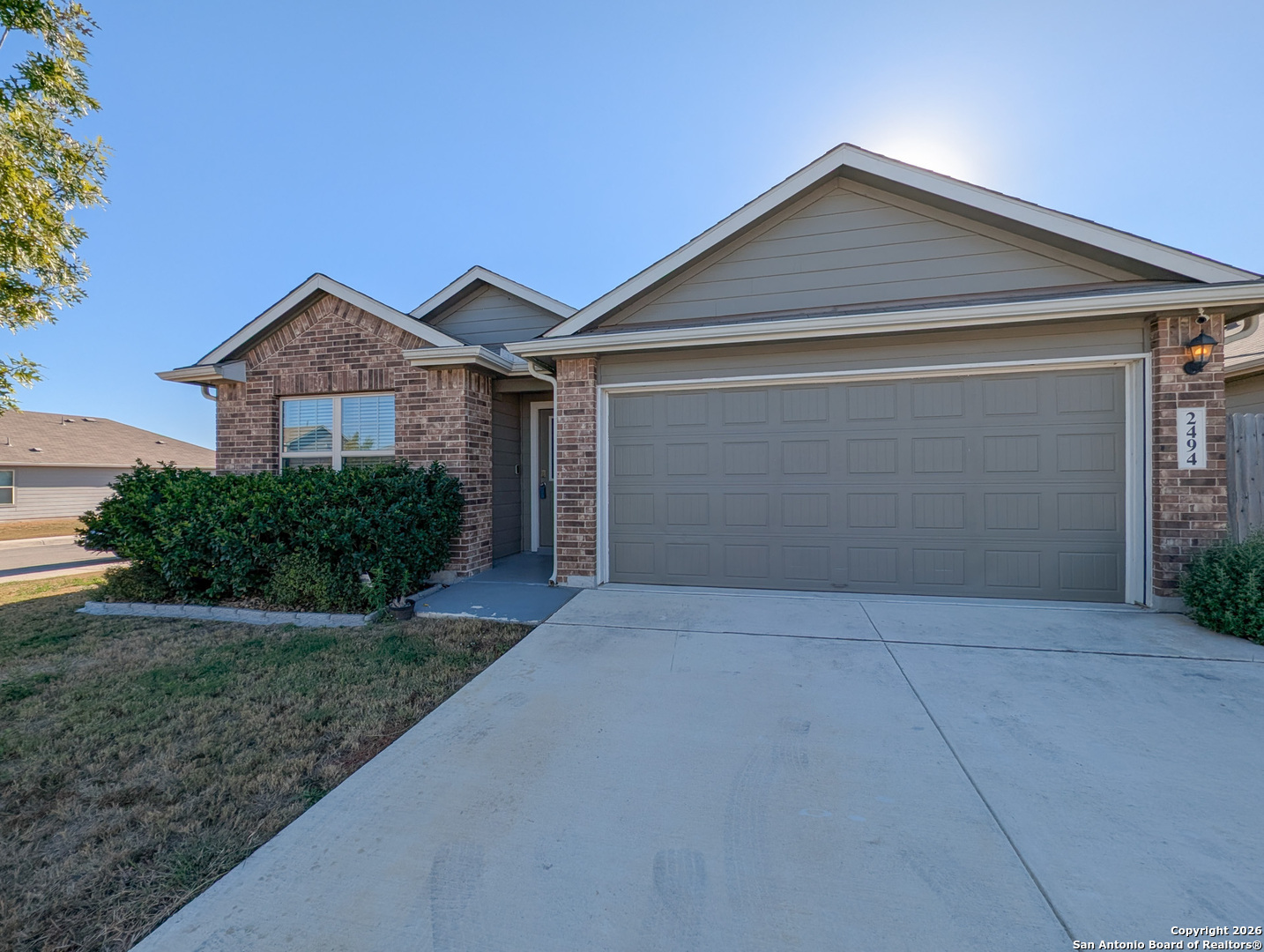 2494 McCrae New Braunfels, TX 78130 - Photo 2 of 22 a front view of a house with a yard and garage