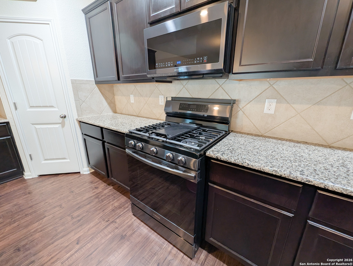 2494 McCrae New Braunfels, TX 78130 - Photo 7 of 22 a kitchen with a stove and a microwave