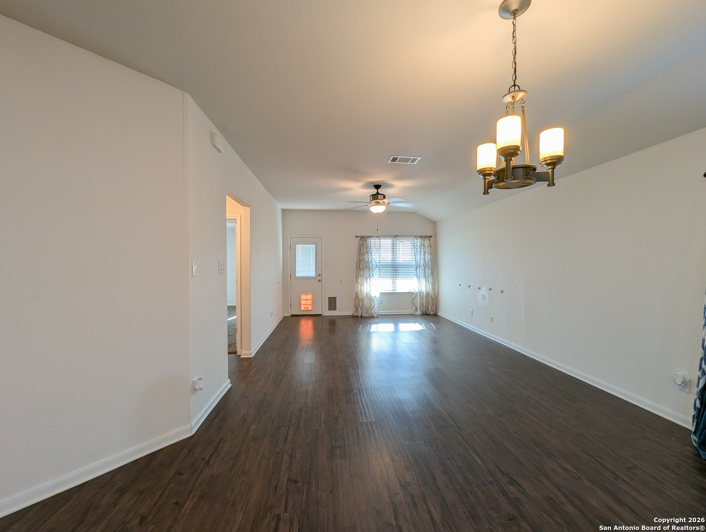 2494 McCrae New Braunfels, TX 78130 - Photo 8 of 22 a view of a room with wooden floor chandelier and windows
