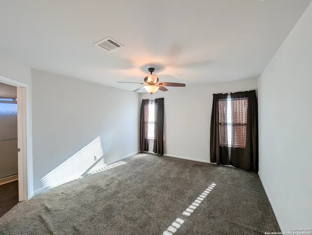a view of a chandelier fan and entryway